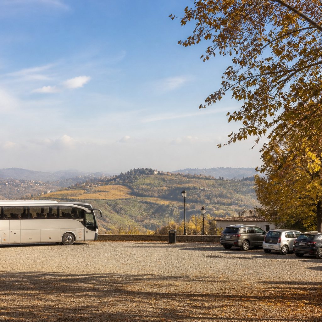 Parcheggio in ghiaia al margine di un paese con una navetta in attesa e alberi autunnali